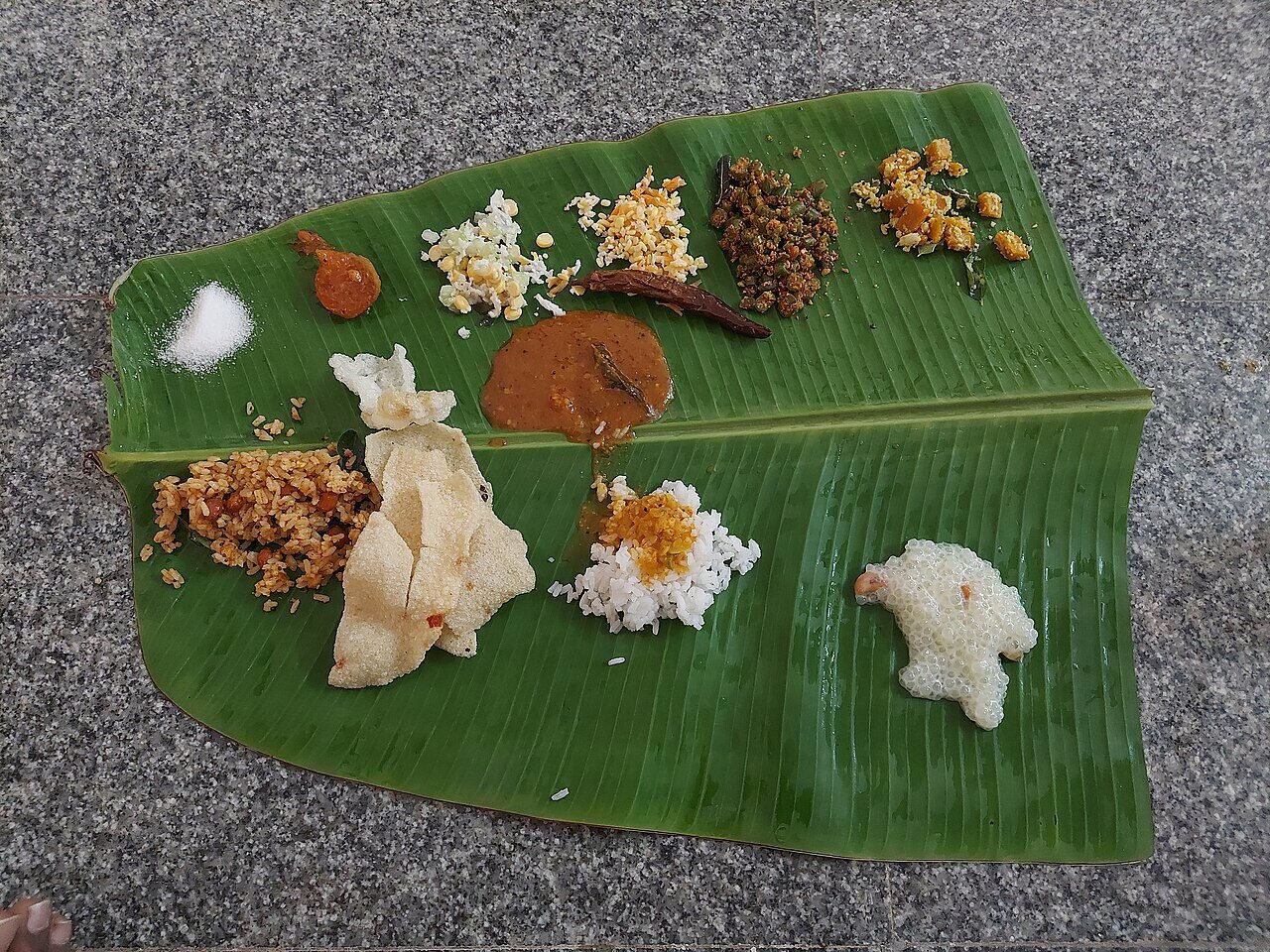 Complete South Indian vegetarian banana leaf rice set with rice, vegetables, curries and accompaniments
